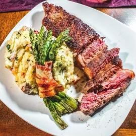 New York Strip with Red Mashed Potatoes and Asparagus Wrapped in Bacon